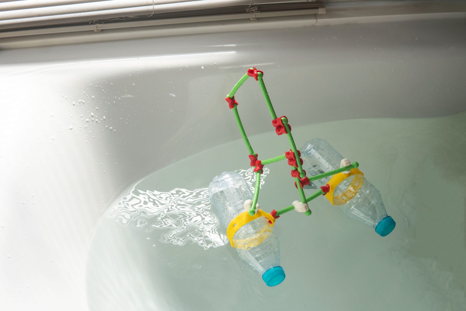 A boat made from plastic bottles floating in a bath