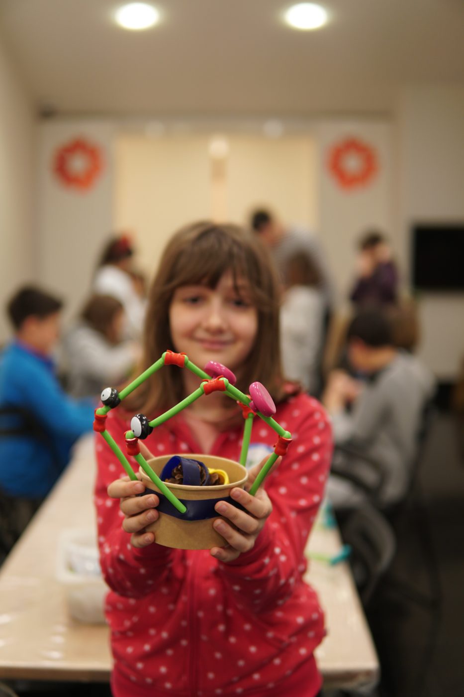 A girl showing the toy she built